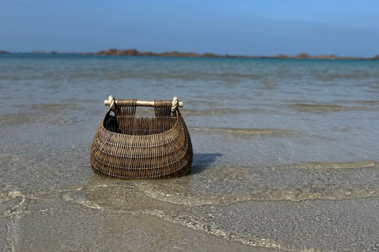 Guernsey fishing basket on the beach shoreline